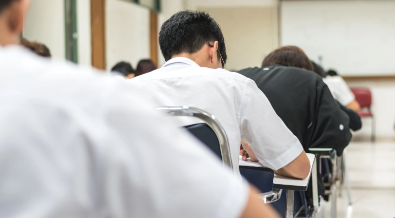 high-schooler-at-desk-studying-classroom